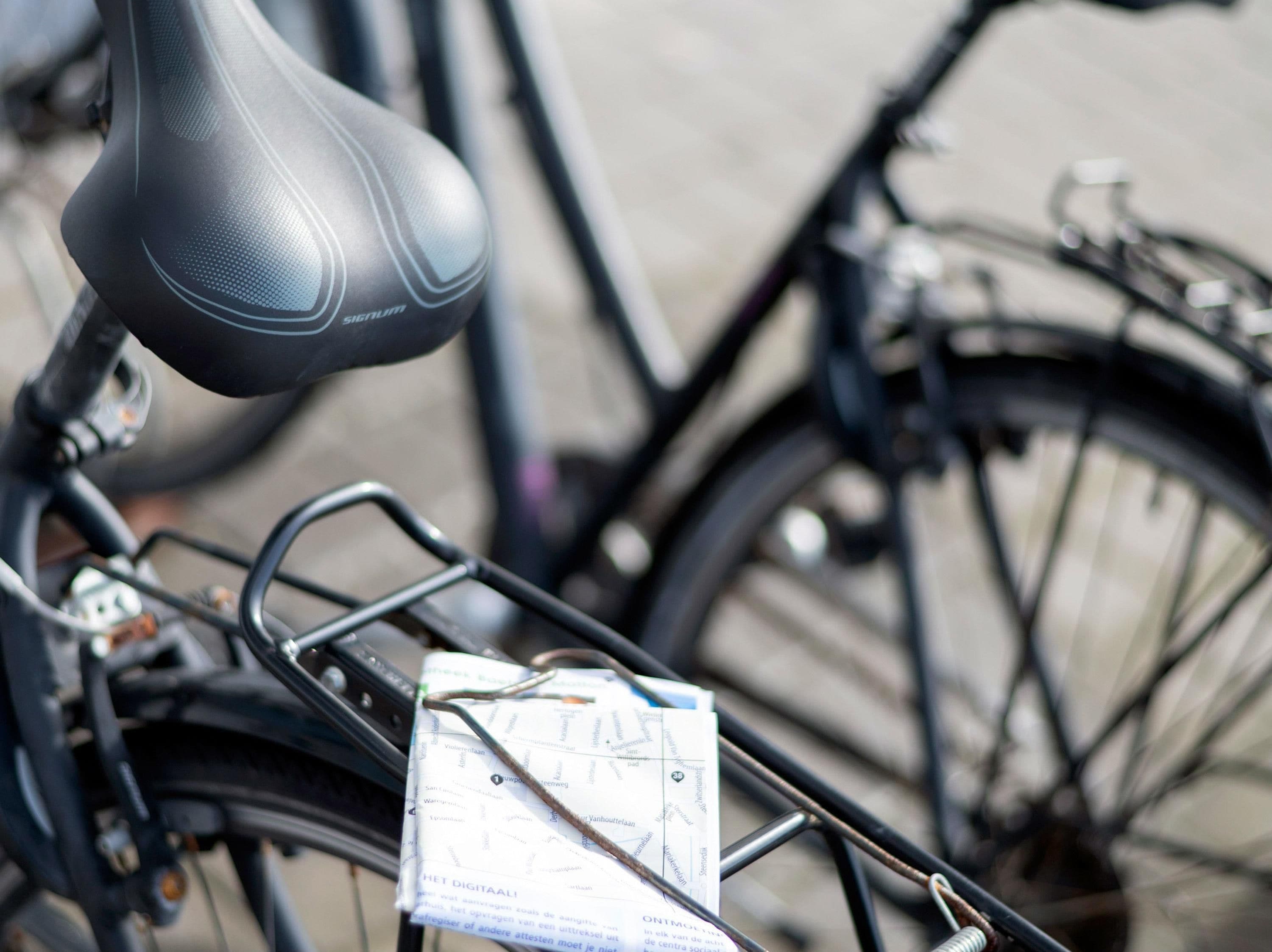 A bicycle with a map and a lock attached to the frame.