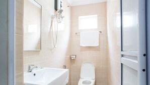 A modern bathroom with a sink, toilet, and shower. - Moment Hotel (Petaling Jaya)