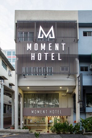 A hotel named 'Moment Hotel' with a modern facade, large windows, and a visible entrance. - Moment Hotel (Petaling Jaya)