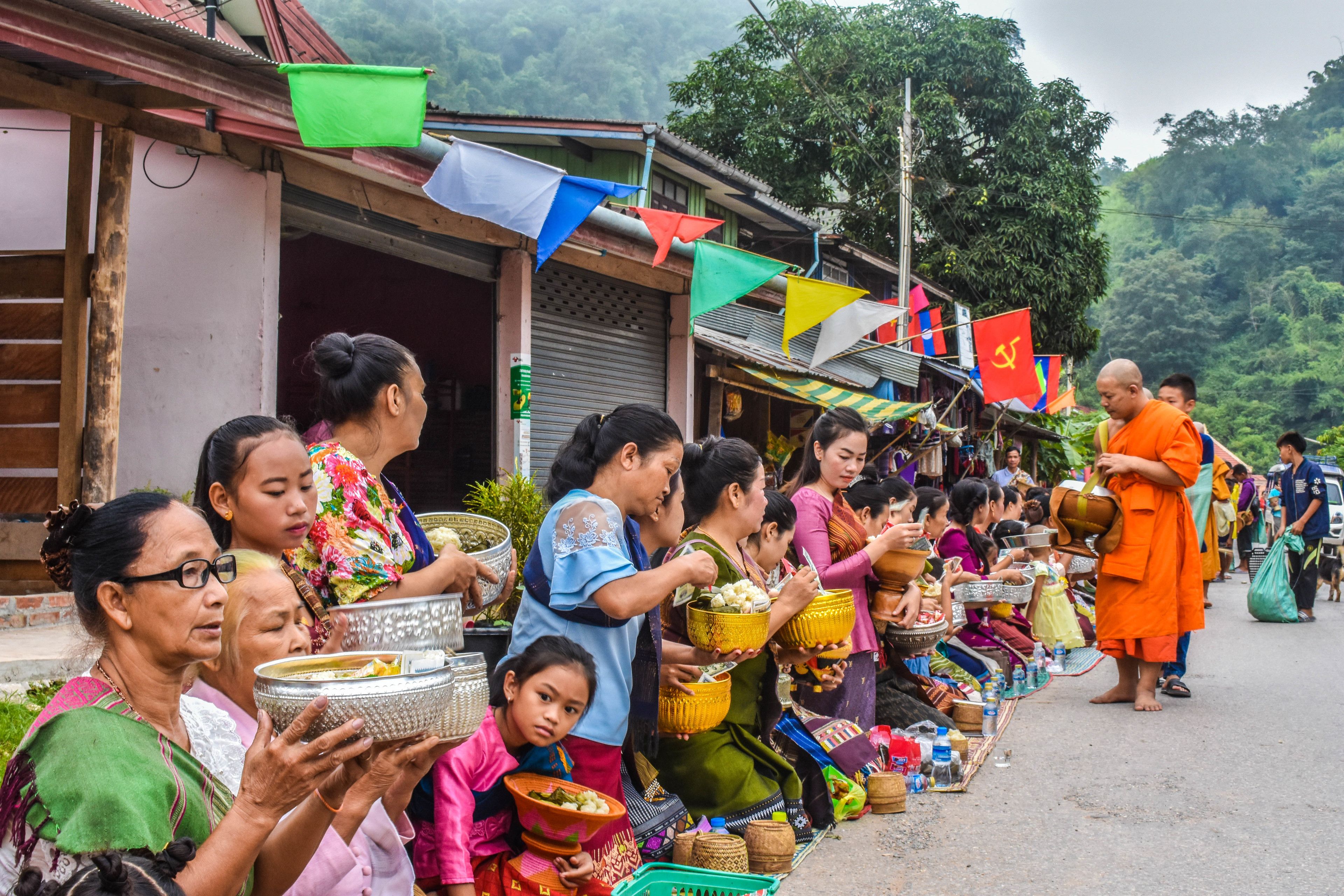 A street market with people selling and buying goods.