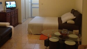A bedroom with a bed, a desk, a chair, and a television. - Pretty studio in Sainte-Luce bordered by its beautiful beaches (Sainte-Luce)