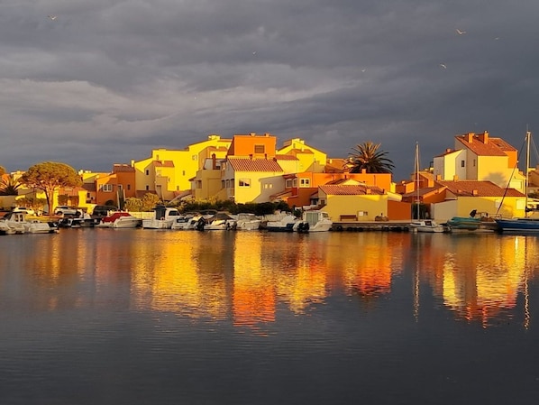 A coastal village with buildings and boats.