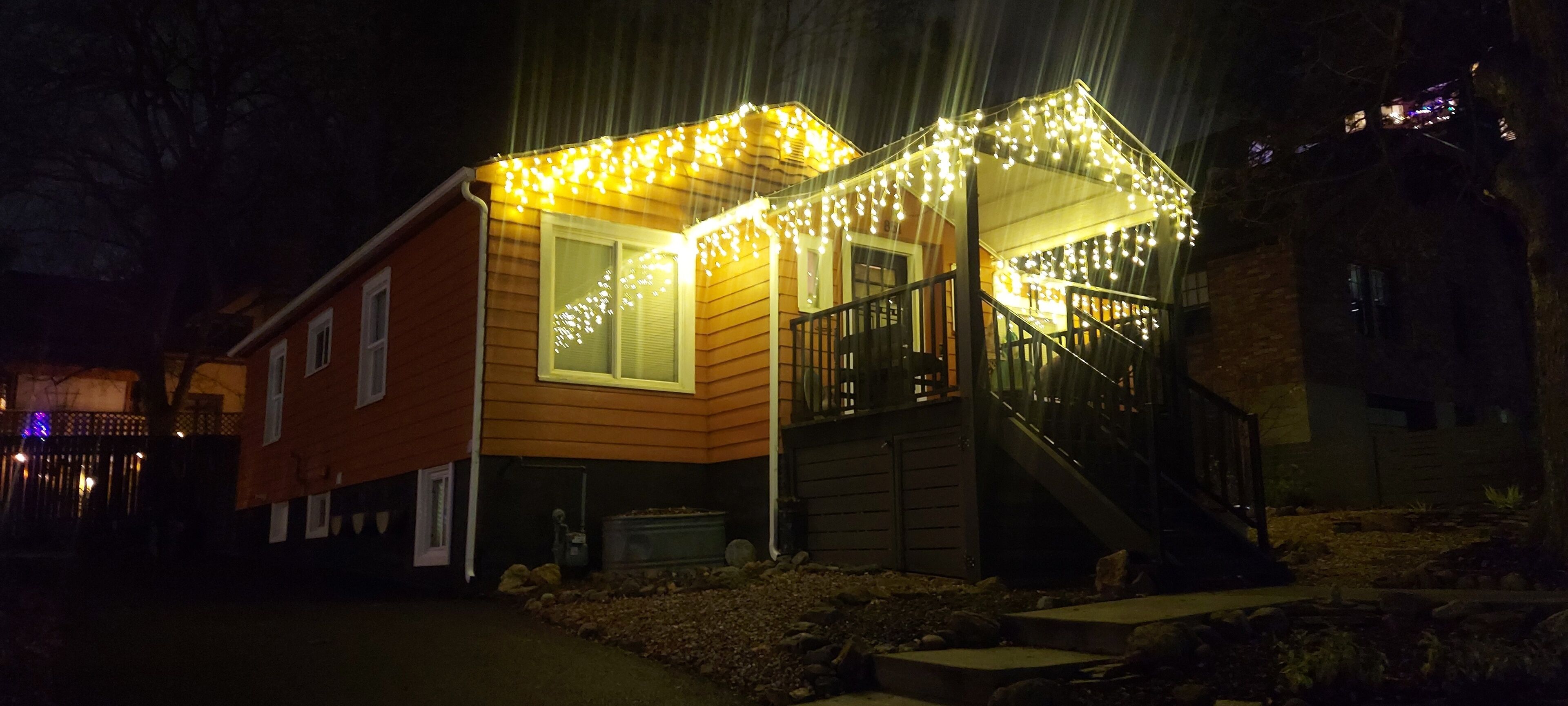 Front of the house at night with Christmas lights on. Your entrance is in back.