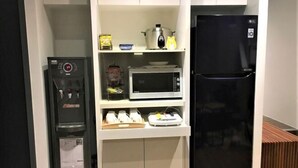 A compact kitchen with a refrigerator, microwave, and a small oven on the countertop. - 109 Inn Taipei (Taipei City)