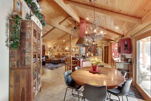 Enjoy meals in the central dining area with a round table and comfortable chairs.