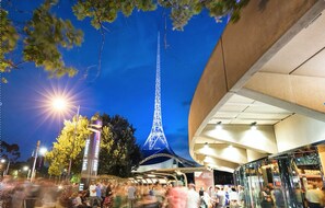 A large, modern building with a curved facade and a prominent glass entrance.