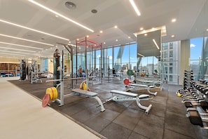 Work out with city views at this gym featuring weight machines, benches, and a punching bag.