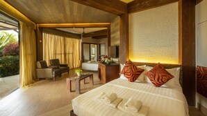 A spacious bedroom with a large bed, a desk, and a sofa. - West 35 Eco Mountain Resort (Balamban)