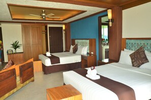 A hotel room with two beds, a wooden headboard, a ceiling fan, a bedside table, and a nightstand. - West 35 Eco Mountain Resort (Balamban)