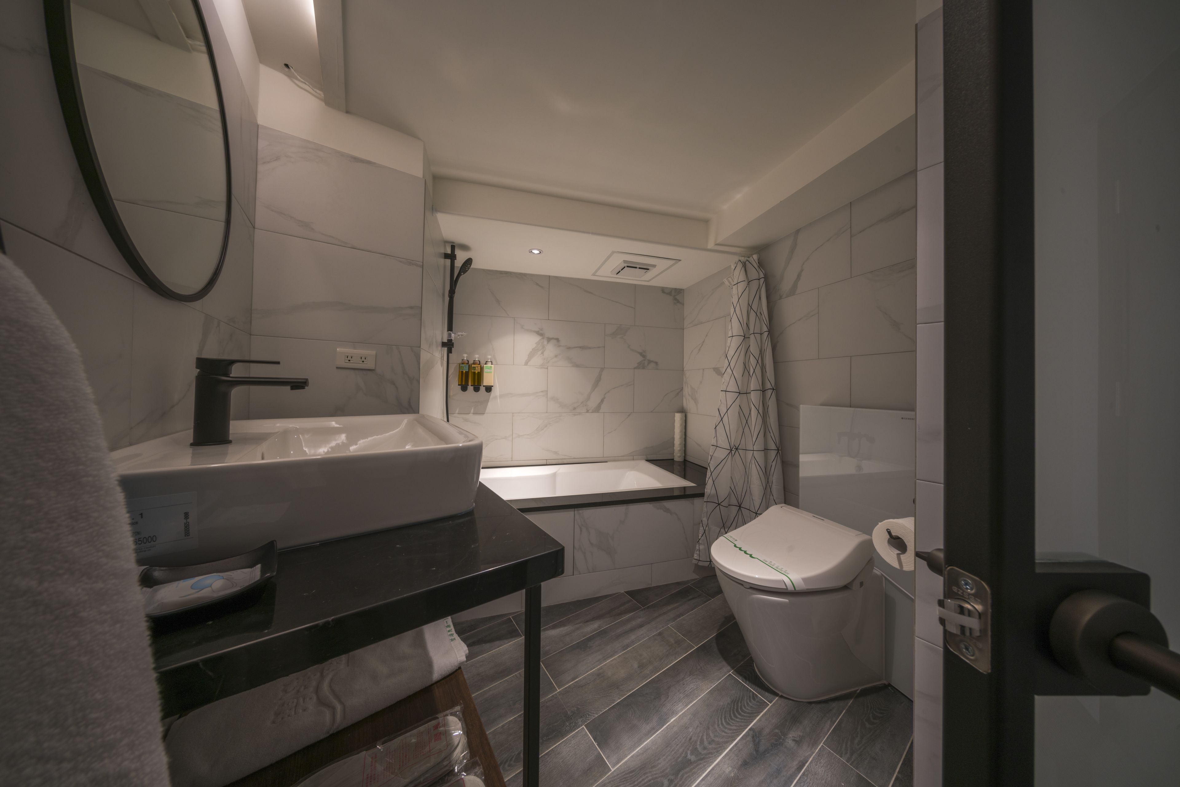 bathtub, hair dryer, towels, soap