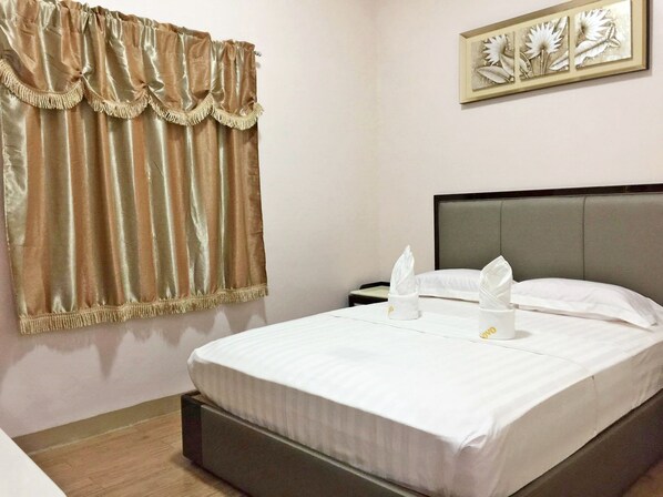 A neatly made bed with white linens, a grey headboard, and a framed floral artwork on the wall. - Meaco Royal Hotel - Lipa (Lipa)