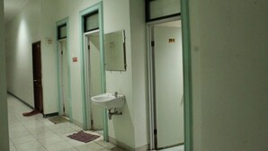 Un pasillo con puertas, un lavabo y un espejo.