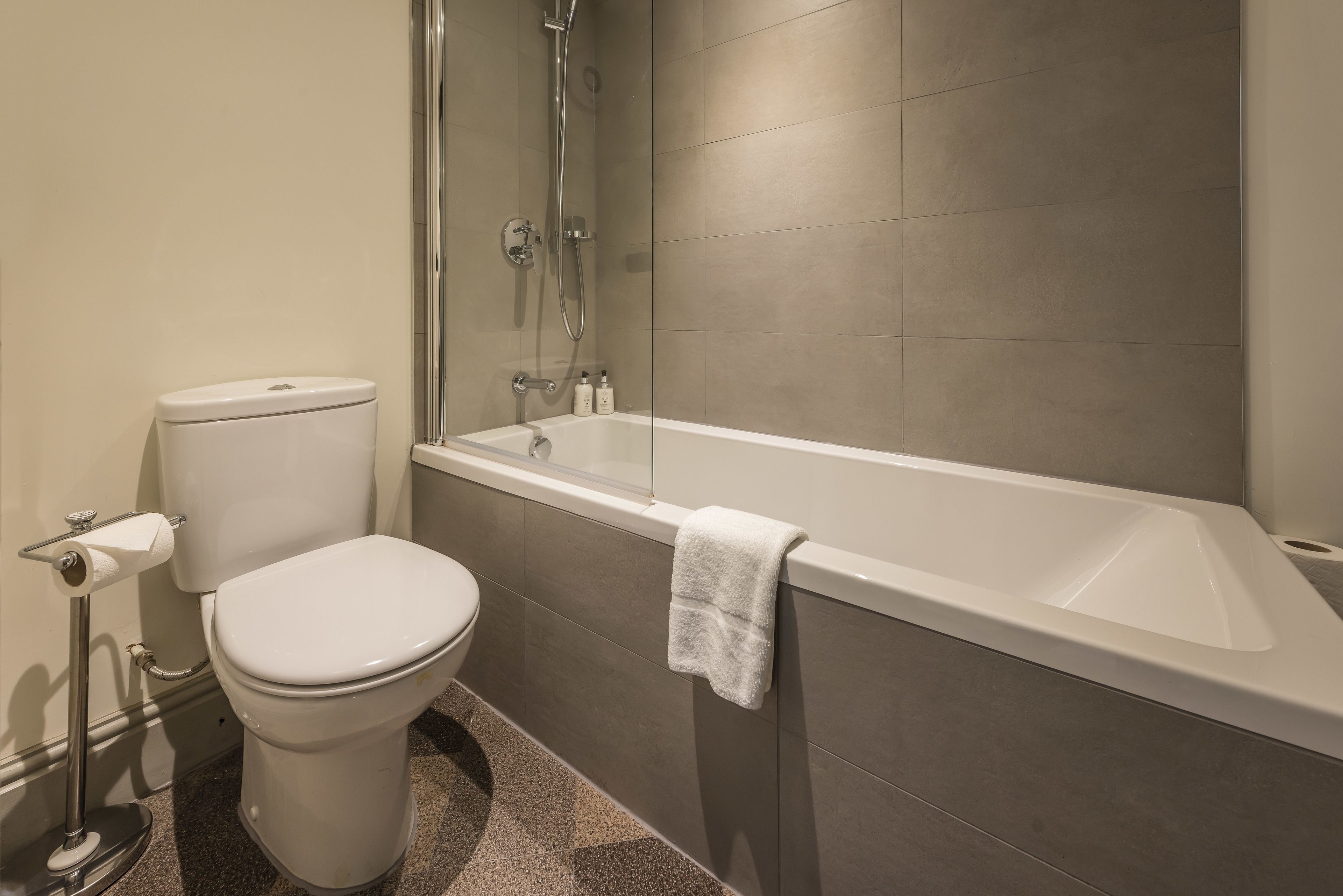 A bathroom with a toilet, a bathtub, and a shower.