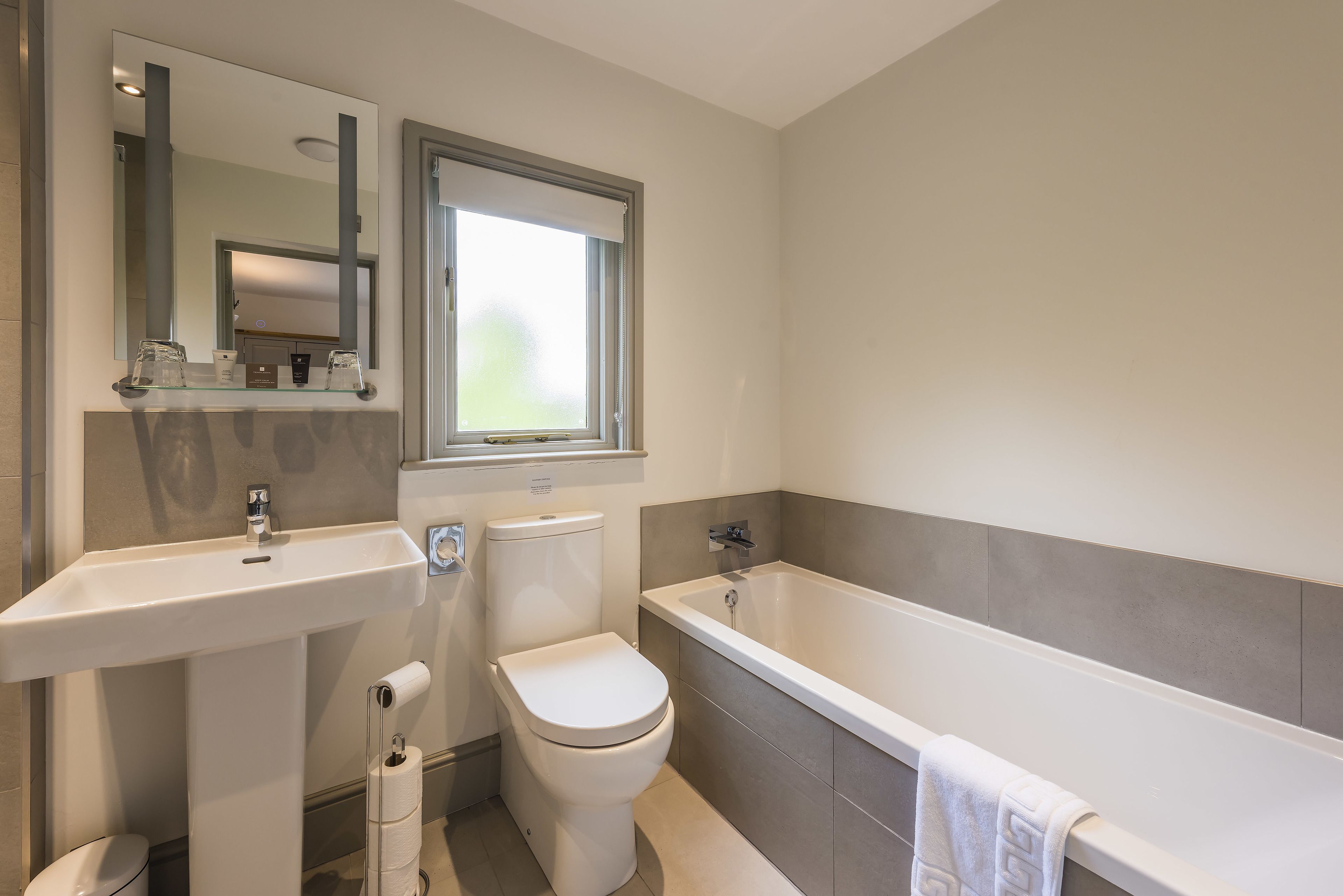 A bathroom with a sink, toilet, and bathtub.