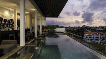 Relax by the rooftop pool with a stunning city view.