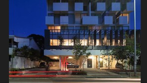 A multi-story building with balconies, large windows, and a well-lit entrance. - ME Colombo (Colombo)