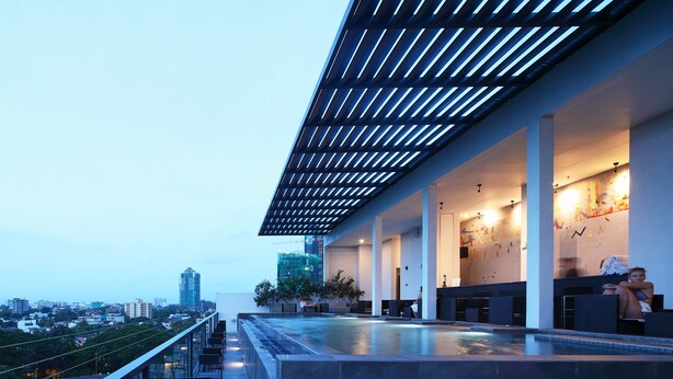 A rooftop terrace with a pool, seating area, and a view of the cityscape. - ME Colombo (Colombo)