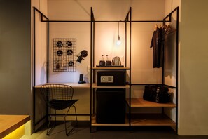 A compact, well-organized room with a desk, chair, shelves, and a wardrobe. - The Hammock Hotel Ben Thanh (Ho Chi Minh City)