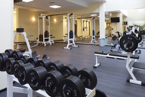 A gym with weightlifting equipment, mirrors, and a variety of exercise machines. - Paradiso Hotel (Nessebar)