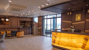 A modern hotel lobby with a reception desk, seating area, and a bar. - Paradiso Hotel (Nessebar)