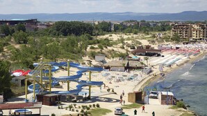 A beach resort with a water park, beach chairs, and a view of the ocean. - Paradiso Hotel (Nessebar)