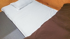 A wooden bunk bed with a white mattress and a brown blanket. - Guest House Koenji Junjo Hotel (Tokyo)