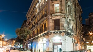 A historic building with multiple stories, featuring ornate balconies and a ground-level shop. - VistaViva B&B (Naples)
