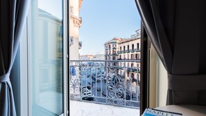 A room with a view of a city street through a window with decorative iron railings. - VistaViva B&B (Naples)