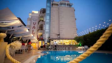 Hotel Vaiz offers a rooftop pool and bar area with comfortable seating.