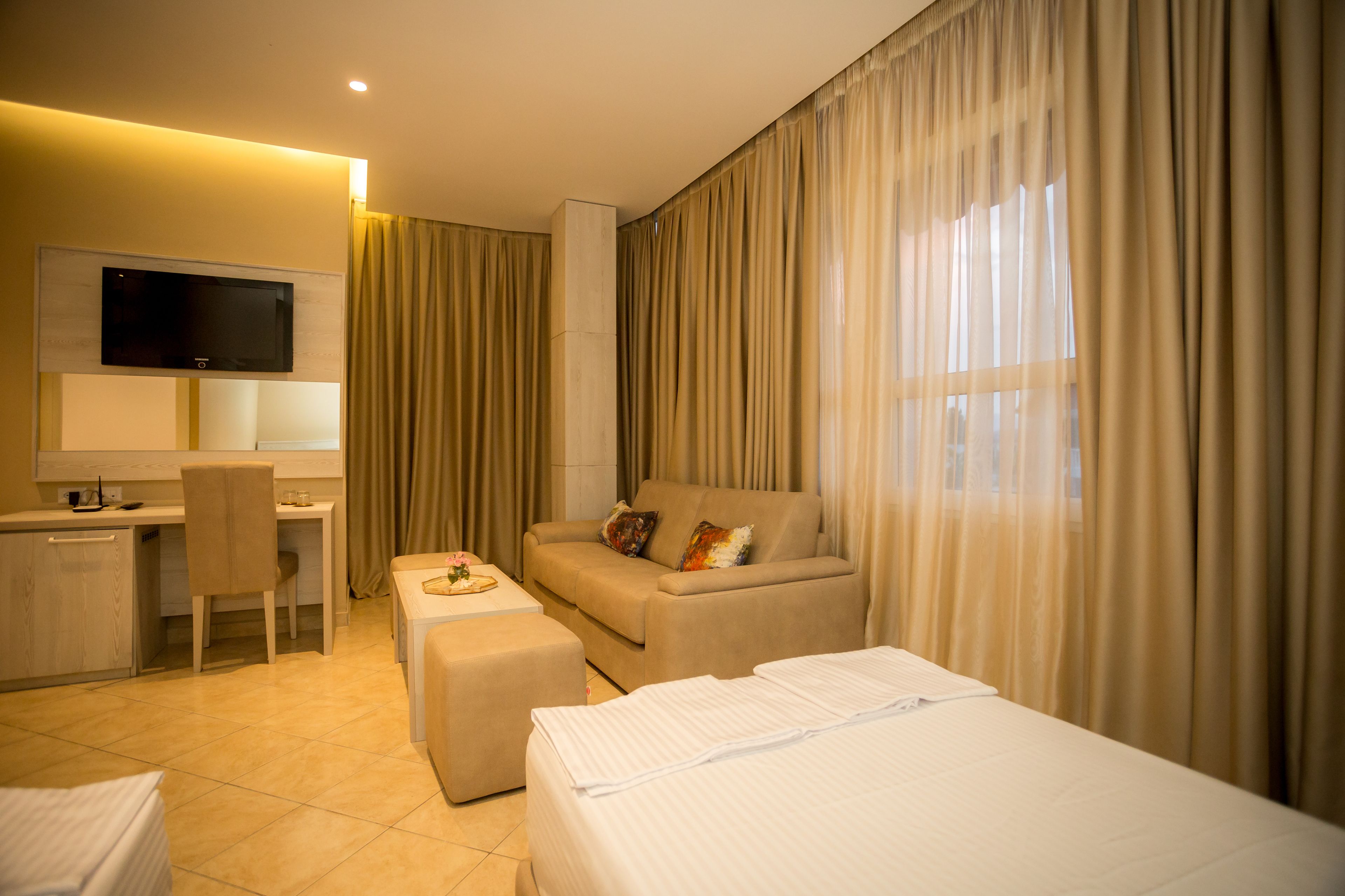 premium bedding, minibar, desk, laptop workspace