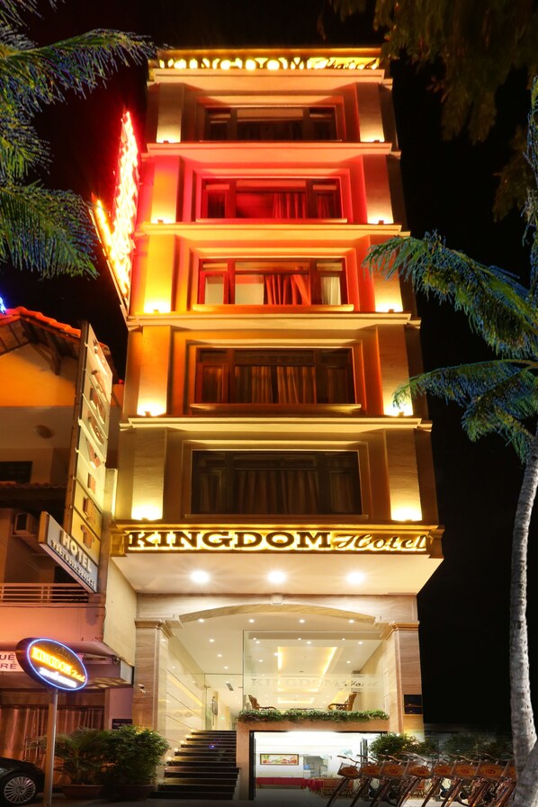 A multi-story hotel with a prominent sign reading "Kingdom Hotel".