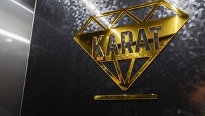 A gold diamond-shaped logo with the word "KARAT" on a dark, textured background. - Karat Hotel (Busan)