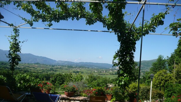 A terrace with chairs and potted plants, overlooking a valley with mountains in the distance. - Il Bruco B&B (San Donato Val Di Comino)