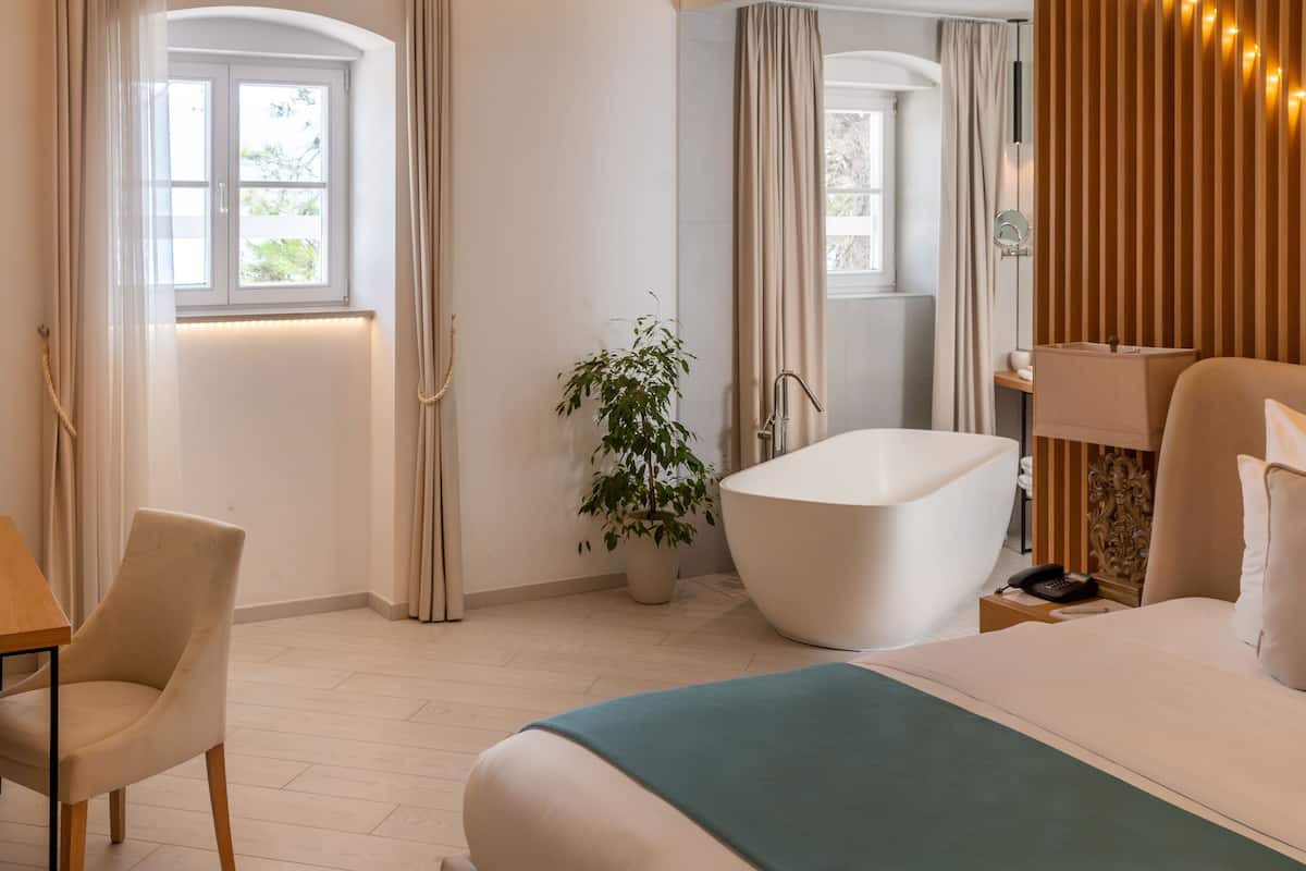 king suite with sea view in historical building | premium bedding, free minibar items, in-room safe, desk