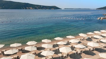 On the beach, sun loungers, beach umbrellas, beach towels