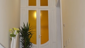 A marble staircase leading to a white door with glass panels. - B&B Domus Palmi (Palmi)
