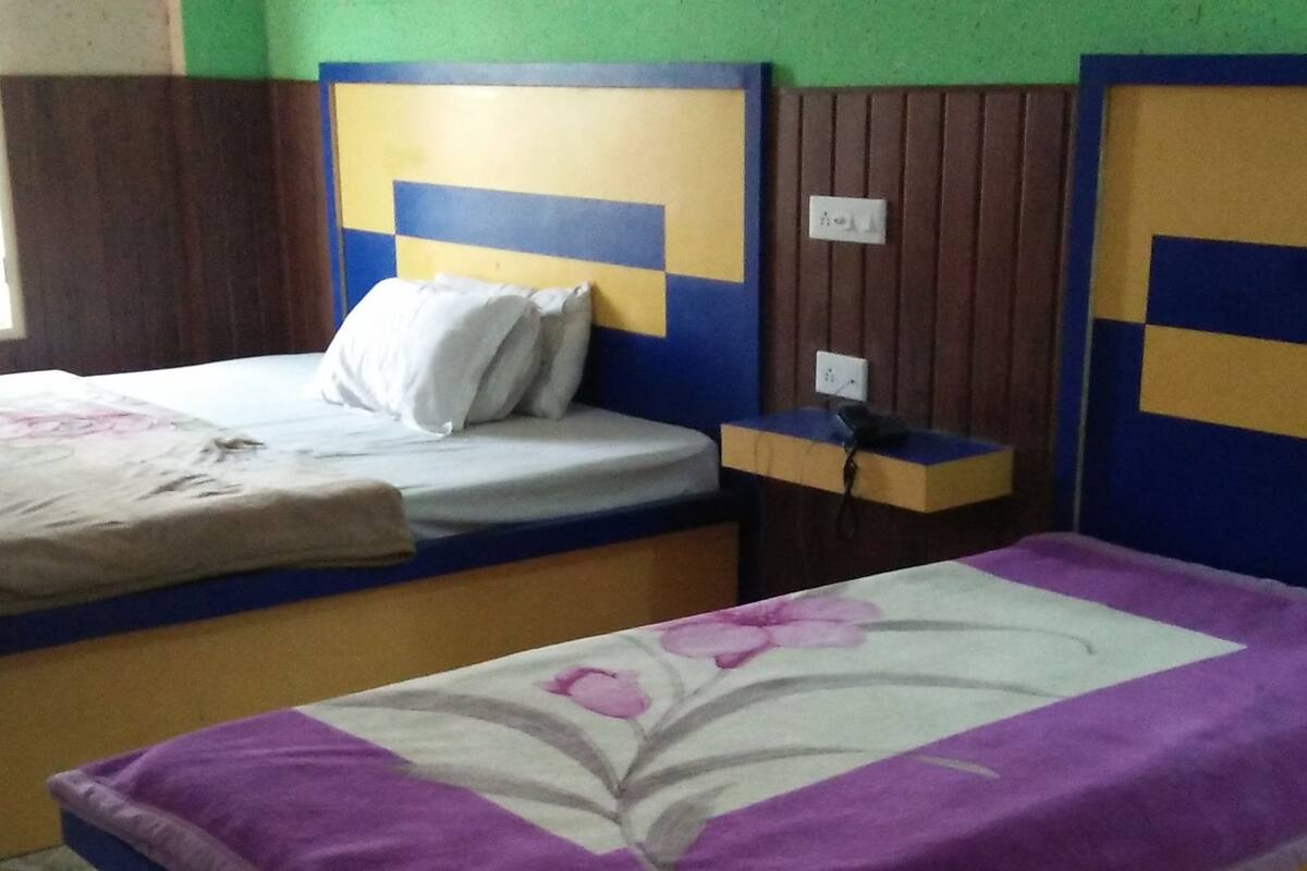 A room with two beds, each with a distinct color scheme.