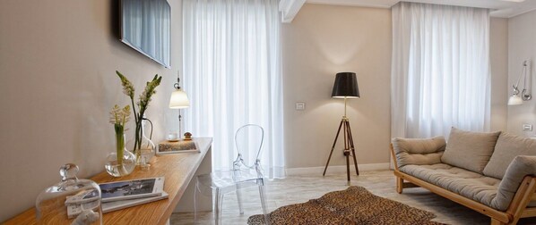 Una sala de estar moderna con un sofá, una mesa de centro, una lámpara, un sillón y una alfombra.