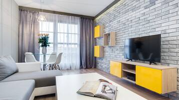 Deluxe Apartment, 1 Bedroom | Living room | 30-inch flat-screen TV with cable channels, TV