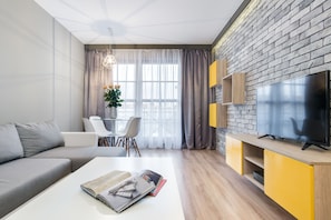 Deluxe Apartment, 1 Bedroom | Living room | 30-inch flat-screen TV with cable channels, TV - Elite Apartments Spa Zone (Gdansk)
