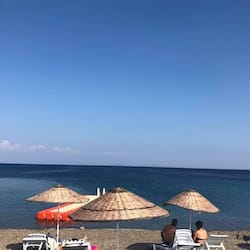 On the beach, white sand, sun-loungers, beach umbrellas