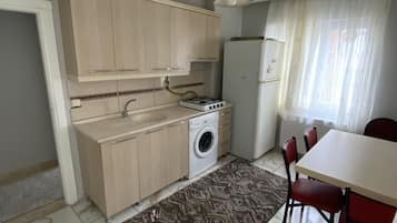 Apartment, 3 Bedrooms, Balcony | Private kitchen | Fridge, coffee/tea maker, electric kettle, cookware/dishes/utensils