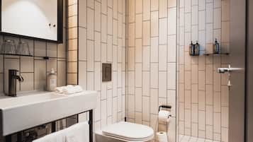 A modern bathroom with a toilet, sink, and shower area.