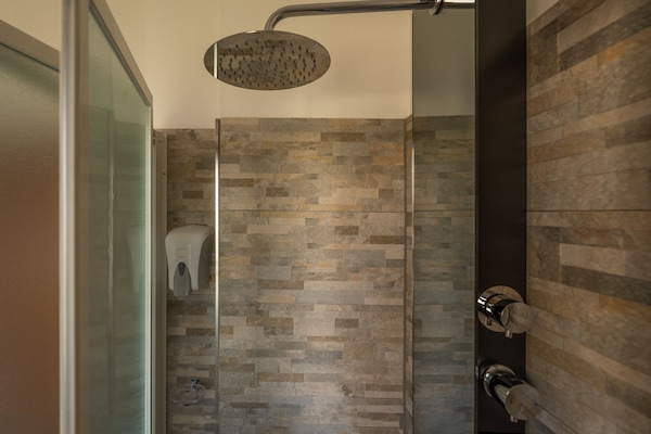 Shower, hydromassage showerhead, eco-friendly toiletries, hair dryer