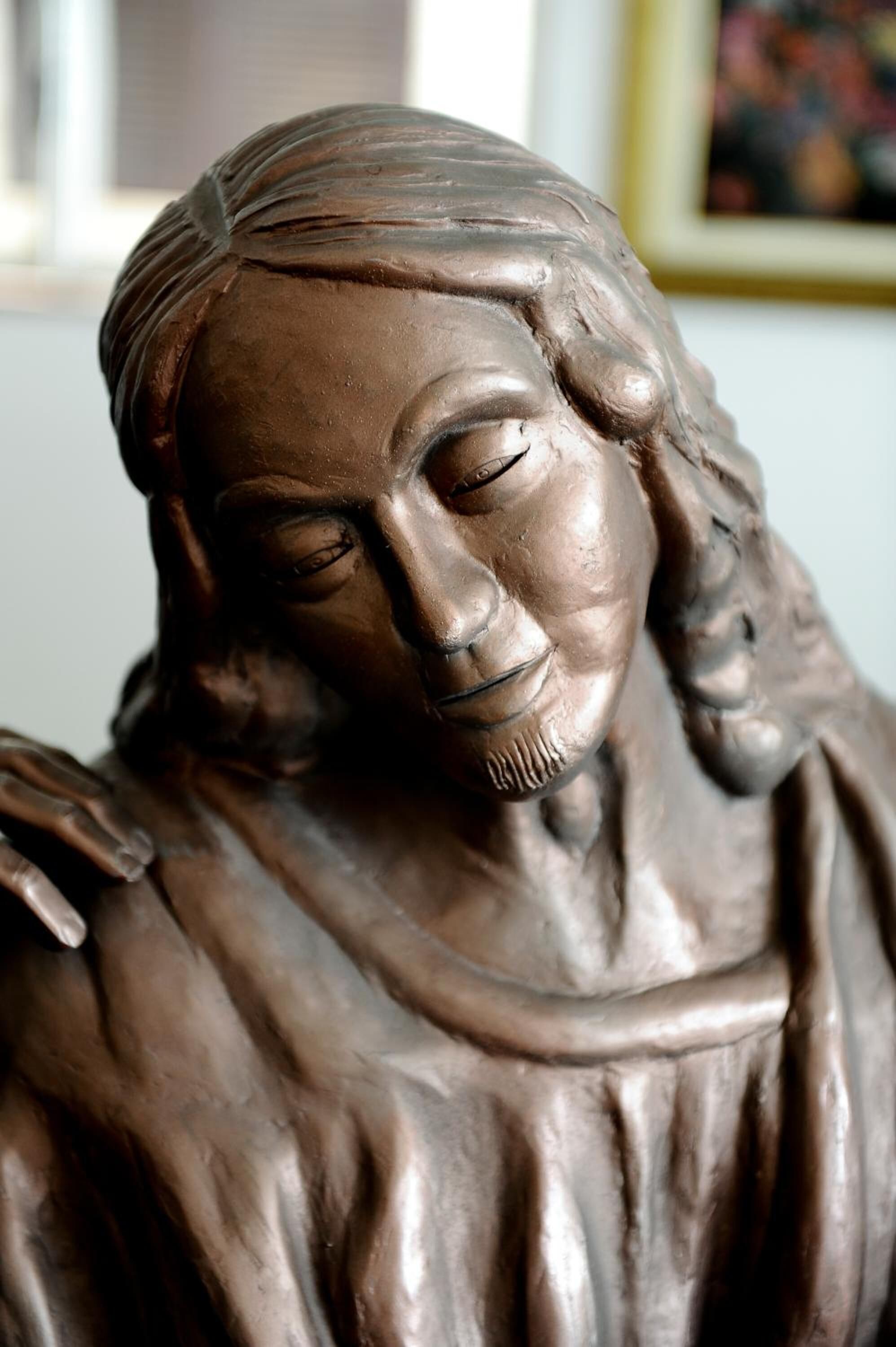 A sculpture of a person with a draped garment.
