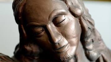 A sculpture of a person with a draped garment.