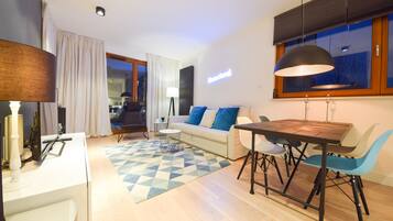 Deluxe Apartment, 1 Bedroom, Garden View | Living area | Flat-screen TV