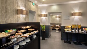A buffet area with various food items and a seating area in the background. - The Republic Hotel (Rome)