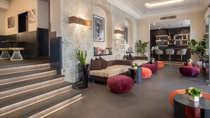 A modern interior with a staircase, seating area, and bar. - The Republic Hotel (Rome)