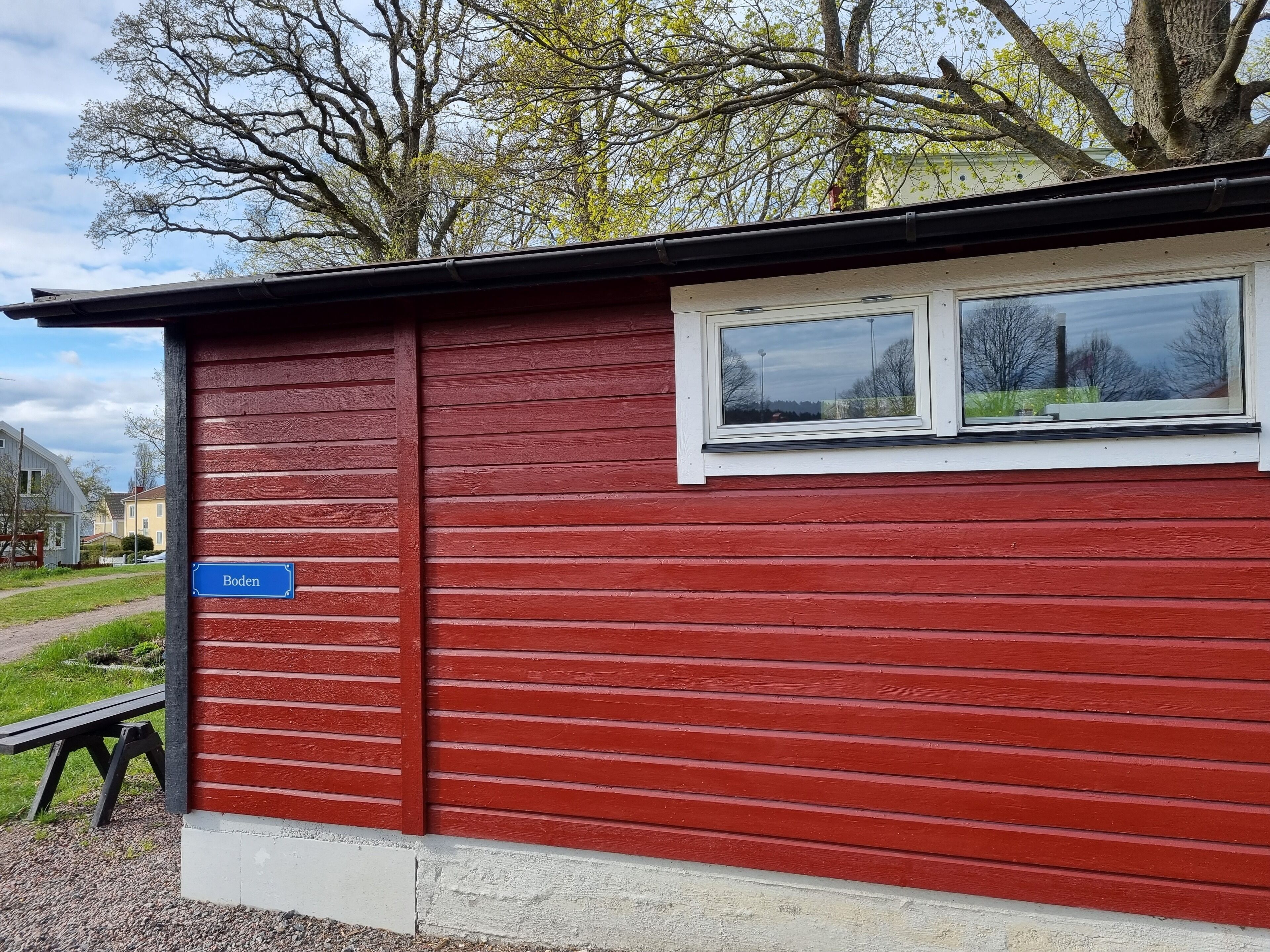 A red building with a window and a sign that reads "Boden".